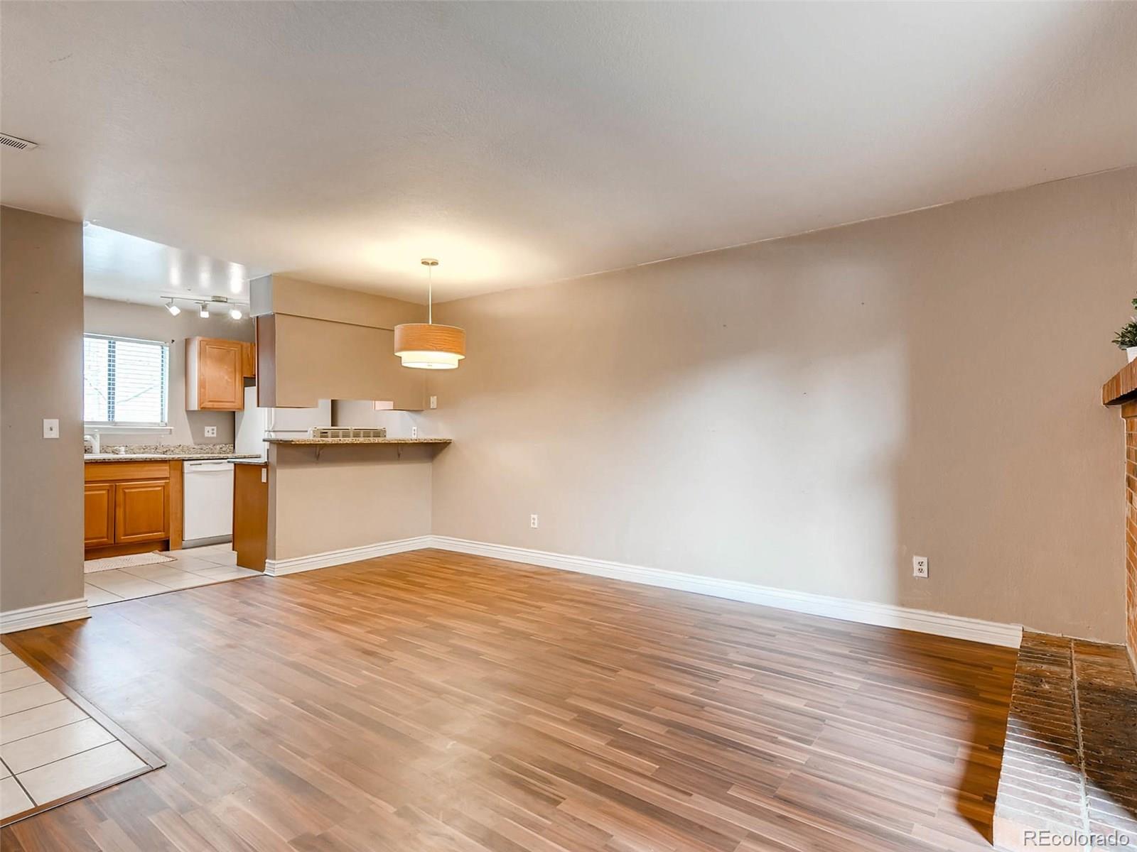 2263 South Buckley Road, Unit 101 Aurora, CO 80013 - Photo 3 of 11 a view of a kitchen with wooden floor