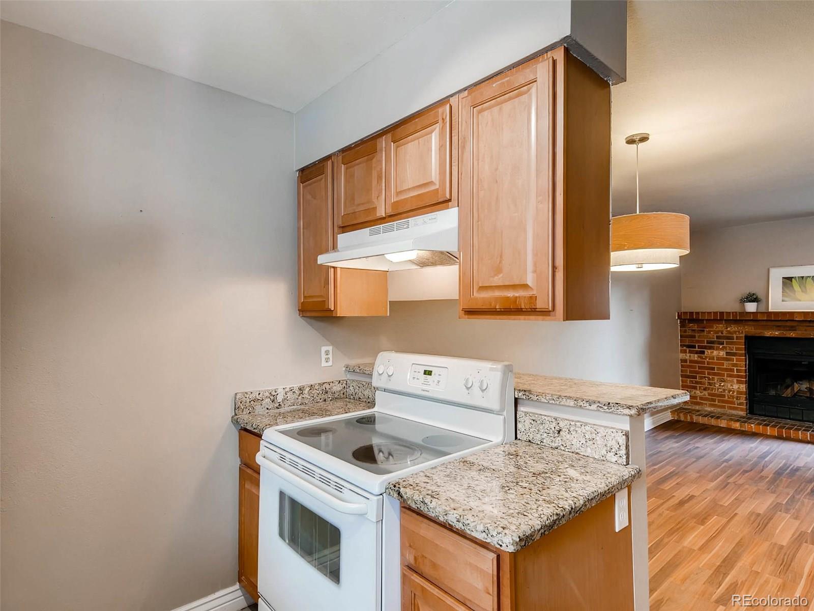 2263 South Buckley Road, Unit 101 Aurora, CO 80013 - Photo 5 of 11 a kitchen with a stove and a sink