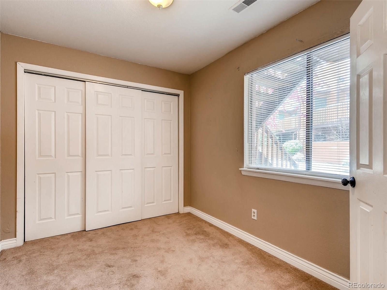 2263 South Buckley Road, Unit 101 Aurora, CO 80013 - Photo 9 of 11 an empty room with windows