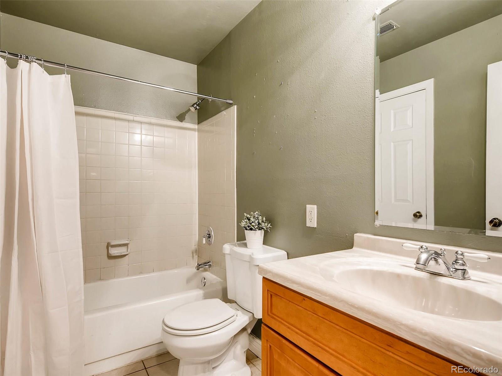 2263 South Buckley Road, Unit 101 Aurora, CO 80013 - Photo 10 of 11 a bathroom with a sink a toilet and shower