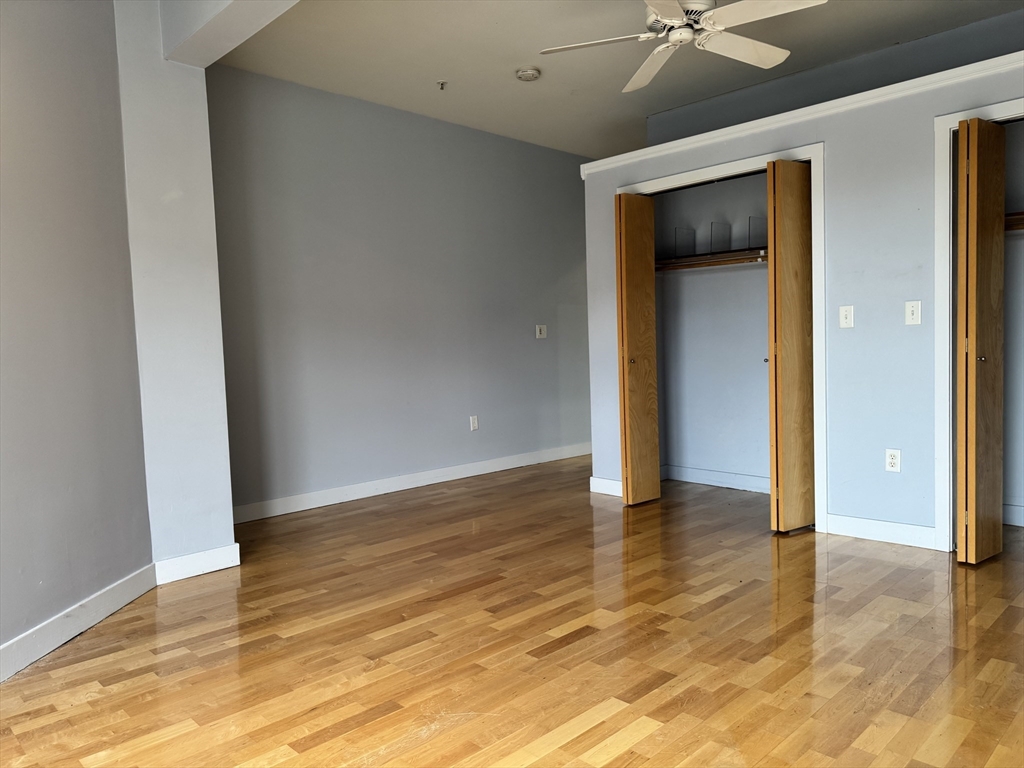 950 Dorchester Avenue, Unit 304 Boston, MA 02125 - Photo 17 of 42 a view of an empty room with wooden floor