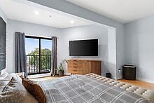 950 Dorchester Avenue, Unit 304 Boston, MA 02125 - Photo 31 of 42 a bedroom with a bed and a flat screen tv