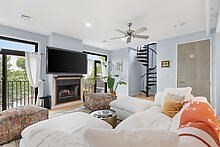 950 Dorchester Avenue, Unit 304 Boston, MA 02125 - Photo 35 of 42 a living room with furniture a fireplace and a flat screen tv