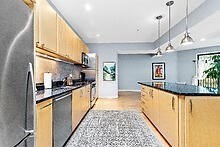 950 Dorchester Avenue, Unit 304 Boston, MA 02125 - Photo 37 of 42 a large kitchen with stainless steel appliances granite countertop a sink and cabinets