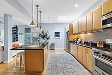 950 Dorchester Avenue, Unit 304 Boston, MA 02125 - Photo 38 of 42 a kitchen with stainless steel appliances granite countertop a stove a sink and a refrigerator