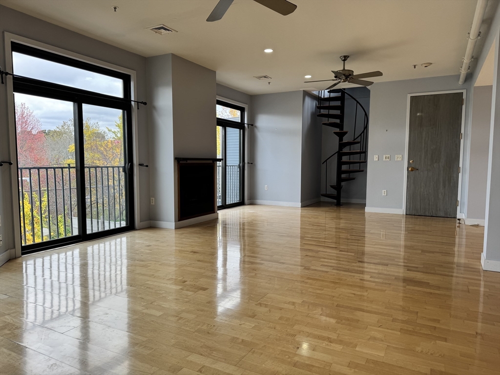 950 Dorchester Avenue, Unit 304 Boston, MA 02125 - Photo 8 of 42 a view of a hallway with wooden floor and staircase