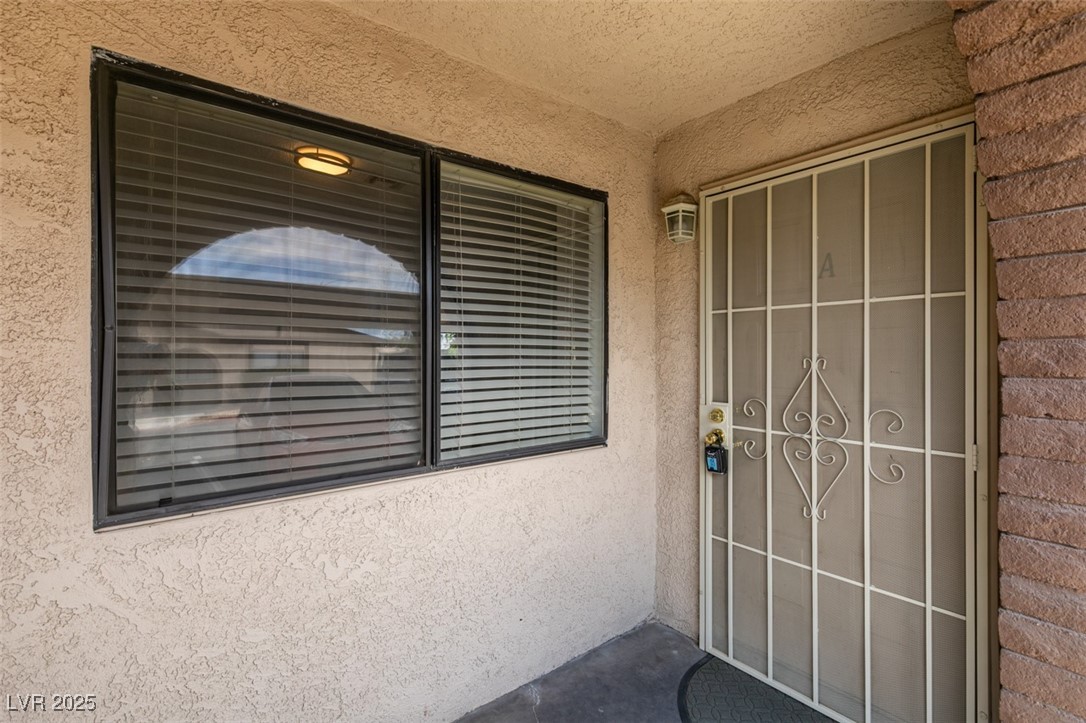 5725 Smoke Ranch Road, Unit A Las Vegas, NV 89108 - Photo 28 of 32 Entrance to property with stucco siding