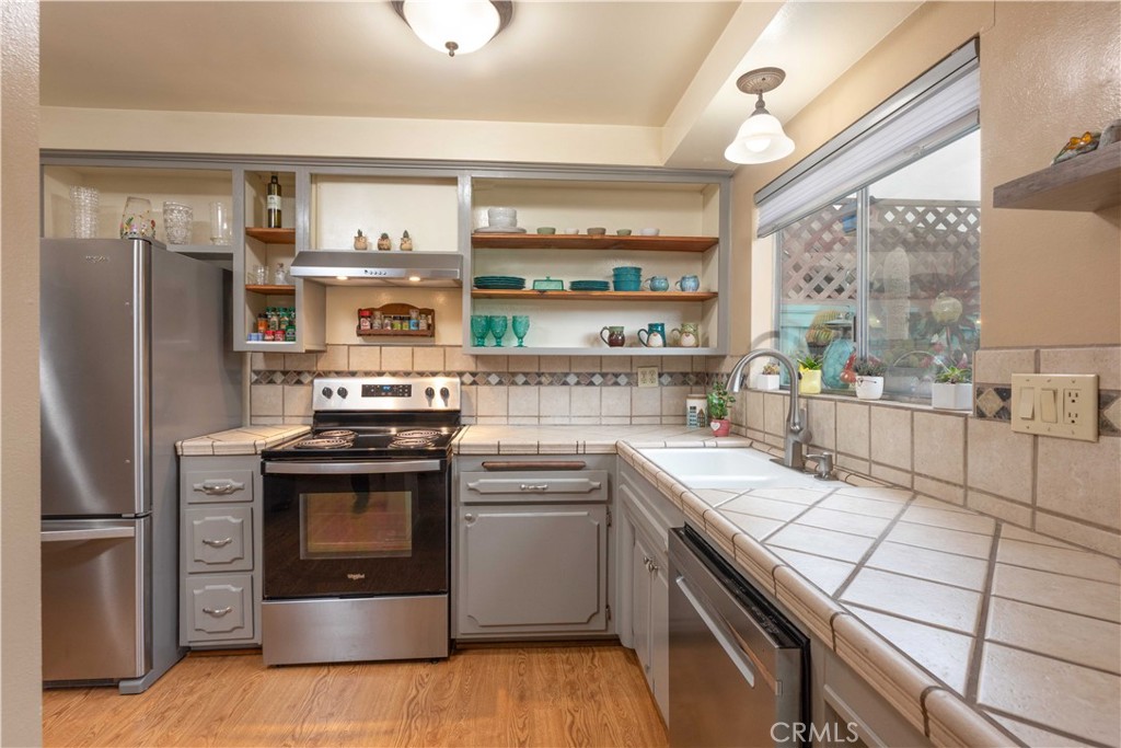 3342 Bradbury Road, Unit 9 Los Alamitos, CA 90720 - Photo 17 of 45 Sunny kitchen with open shelving