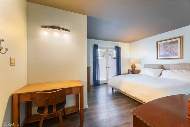 a large bed sitting in a bedroom next to a window