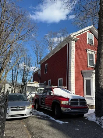 a front view of a house with parking space