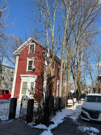 a front view of a building with trees