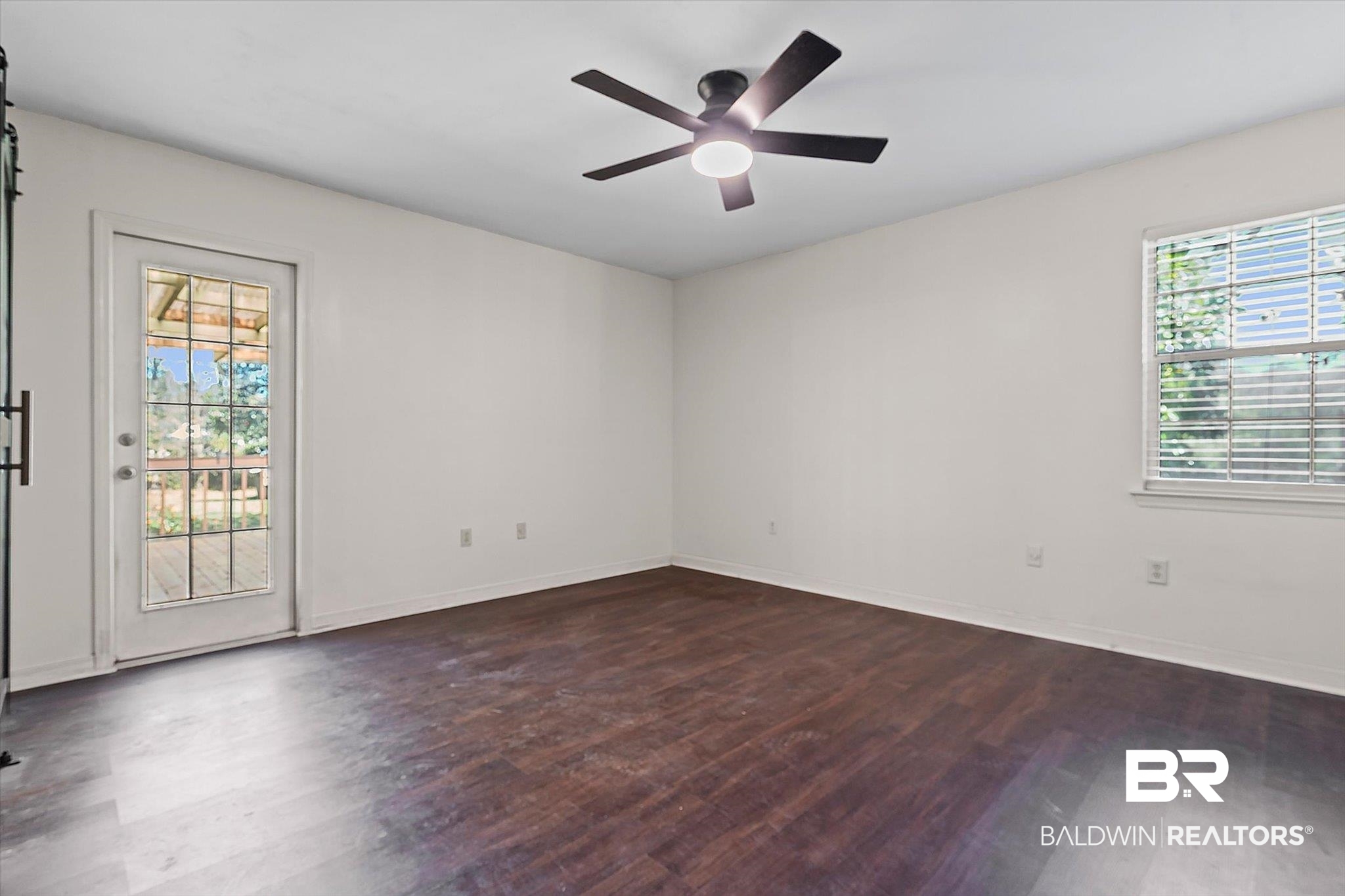 180 Creax Road Axis, AL 36505 - Photo 9 of 35 Empty room with dark wood-style floors and a ceiling fan