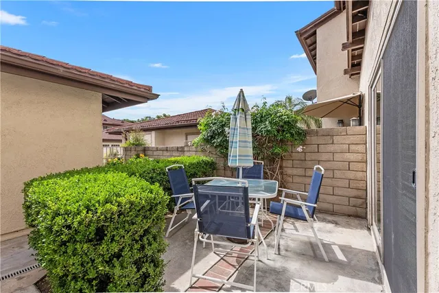a view of backyard with outdoor seating and plants
