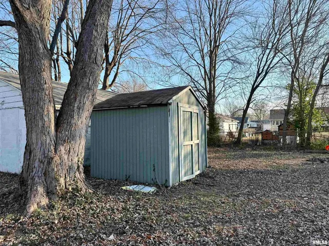 a view of a house with a large tree