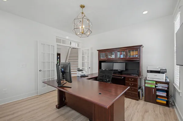a kitchen with white cabinets appliances and wooden floor