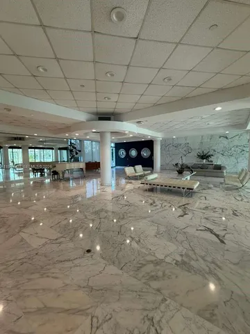 a lobby with furniture and a fireplace