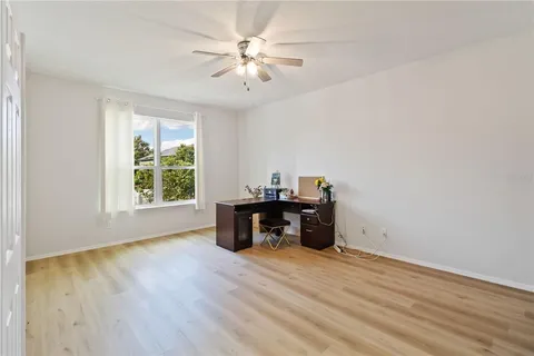 a view of a workspace with furniture and a window