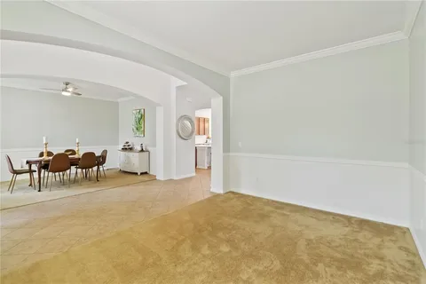 a view of a livingroom with furniture and a chandelier fan