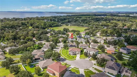 an aerial view of residential houses with outdoor space and swimming pool