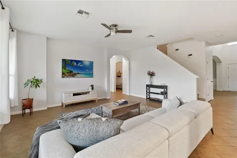 a living room with furniture and a potted plant