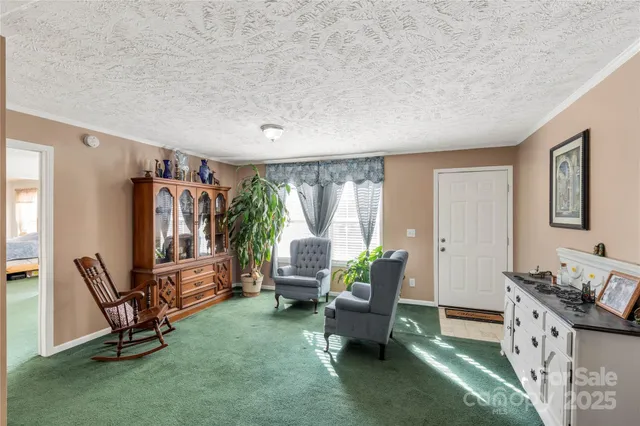 a bedroom with a bed a dresser and next to a window