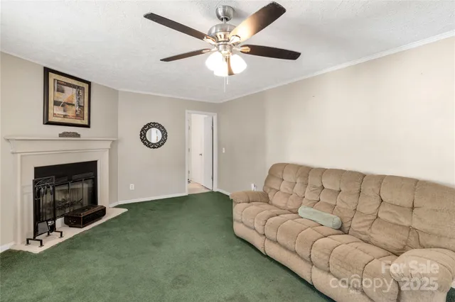 a bedroom with a bed a table and large windows