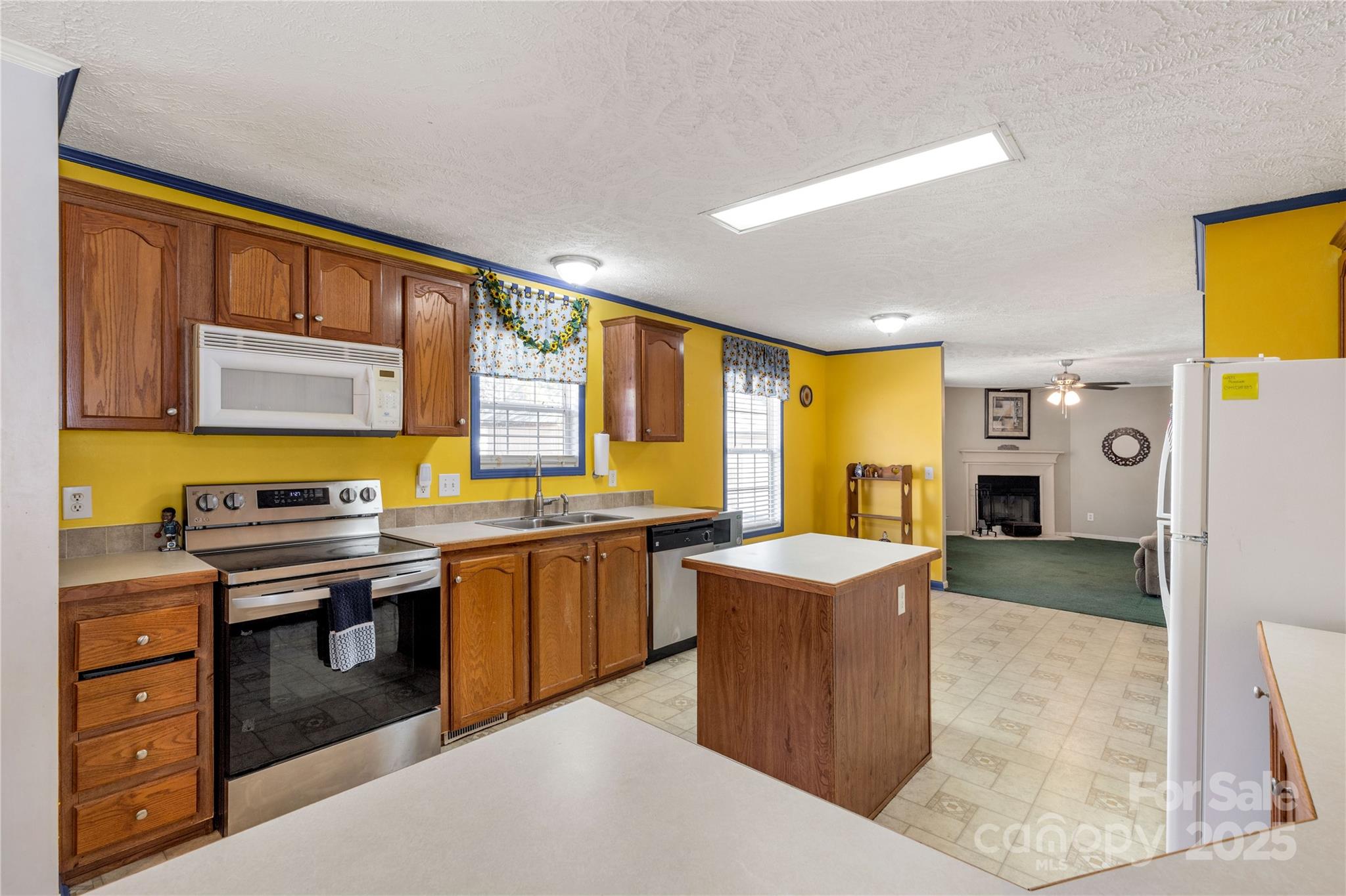 928 Neds Creek Road Kershaw, SC 29067 - Photo 10 of 38 a kitchen with stainless steel appliances granite countertop a sink stove and refrigerator