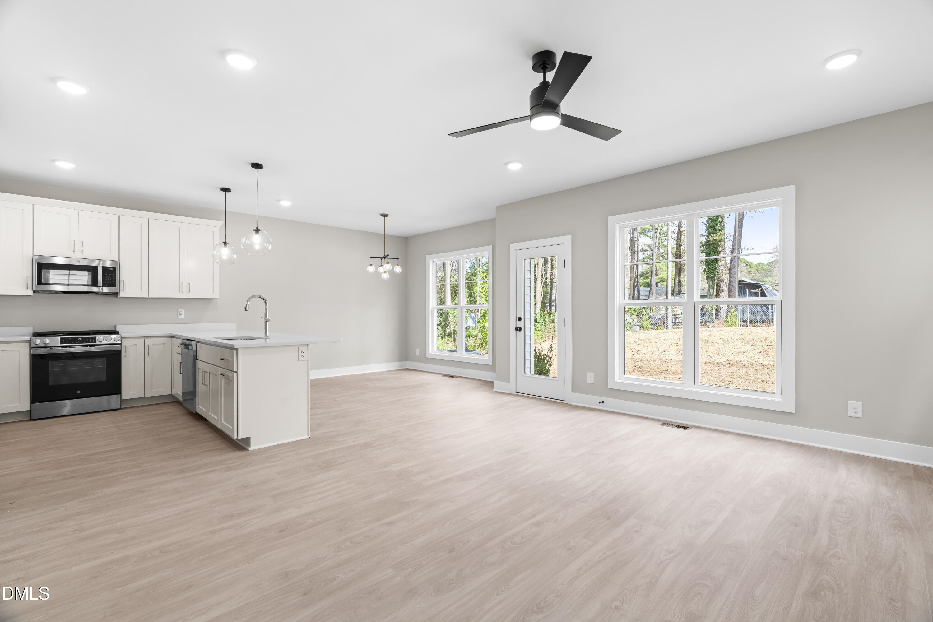 1028 Harper Road Raleigh, NC 27603 - Photo 12 of 50 a view of a kitchen with a stove cabinets and a large window