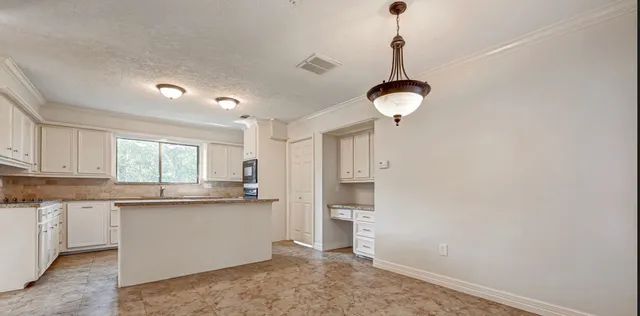 a kitchen with stainless steel appliances granite countertop a sink and cabinets