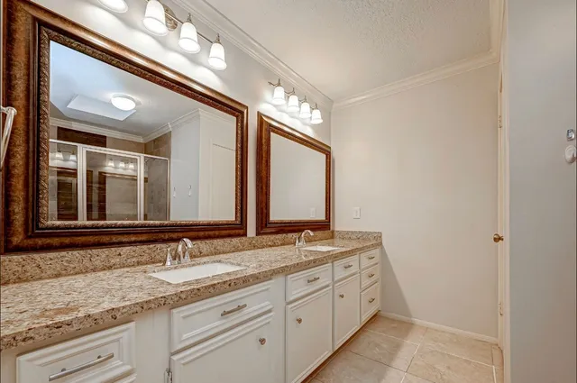 a bathroom with a double vanity sink and a mirror