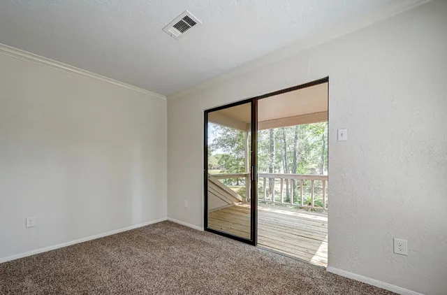 an empty room with large windows