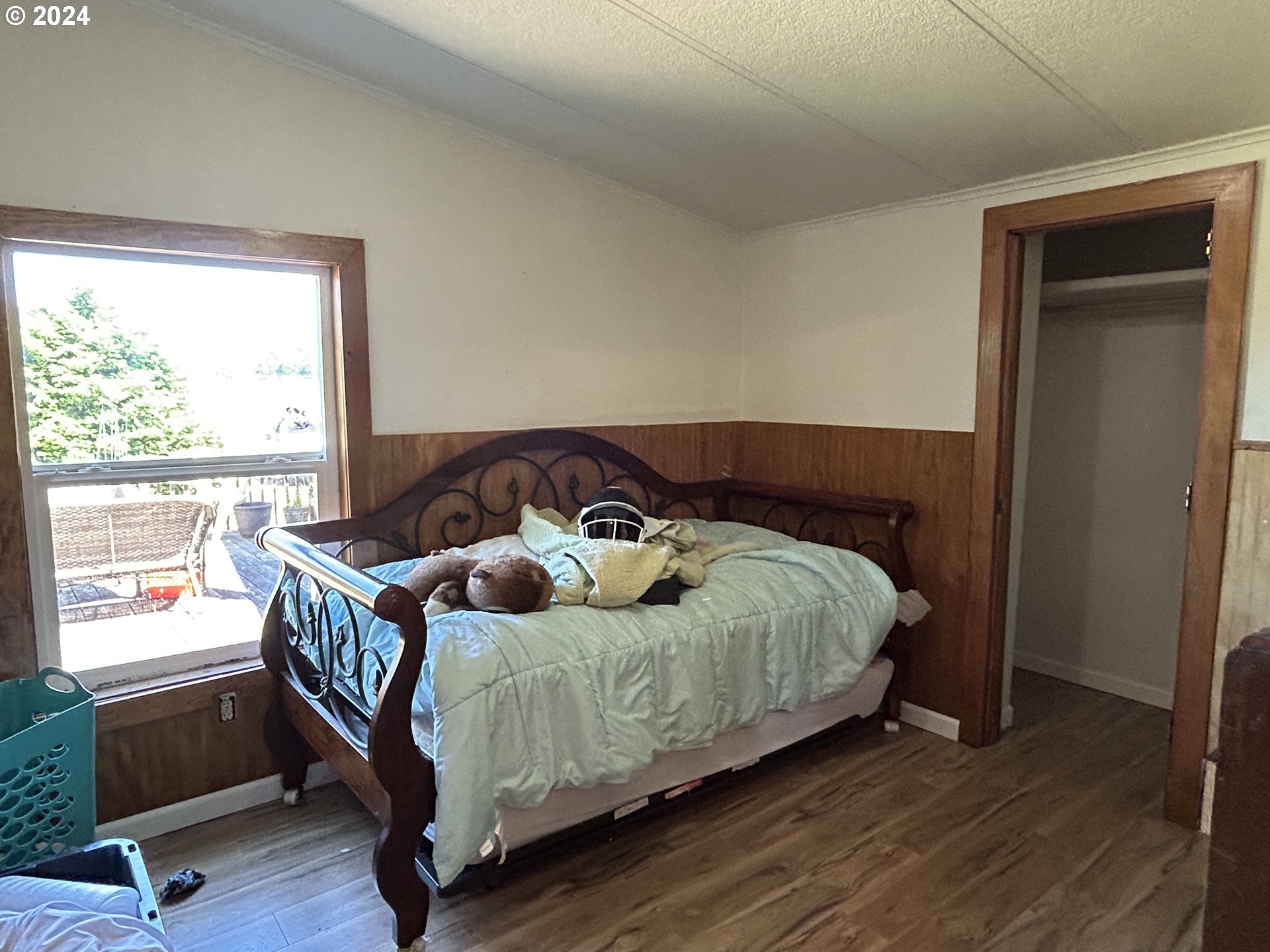 5480 Nonpareil Road Sutherlin, OR 97479 - Photo 27 of 44 a bedroom with a bed and wooden floor