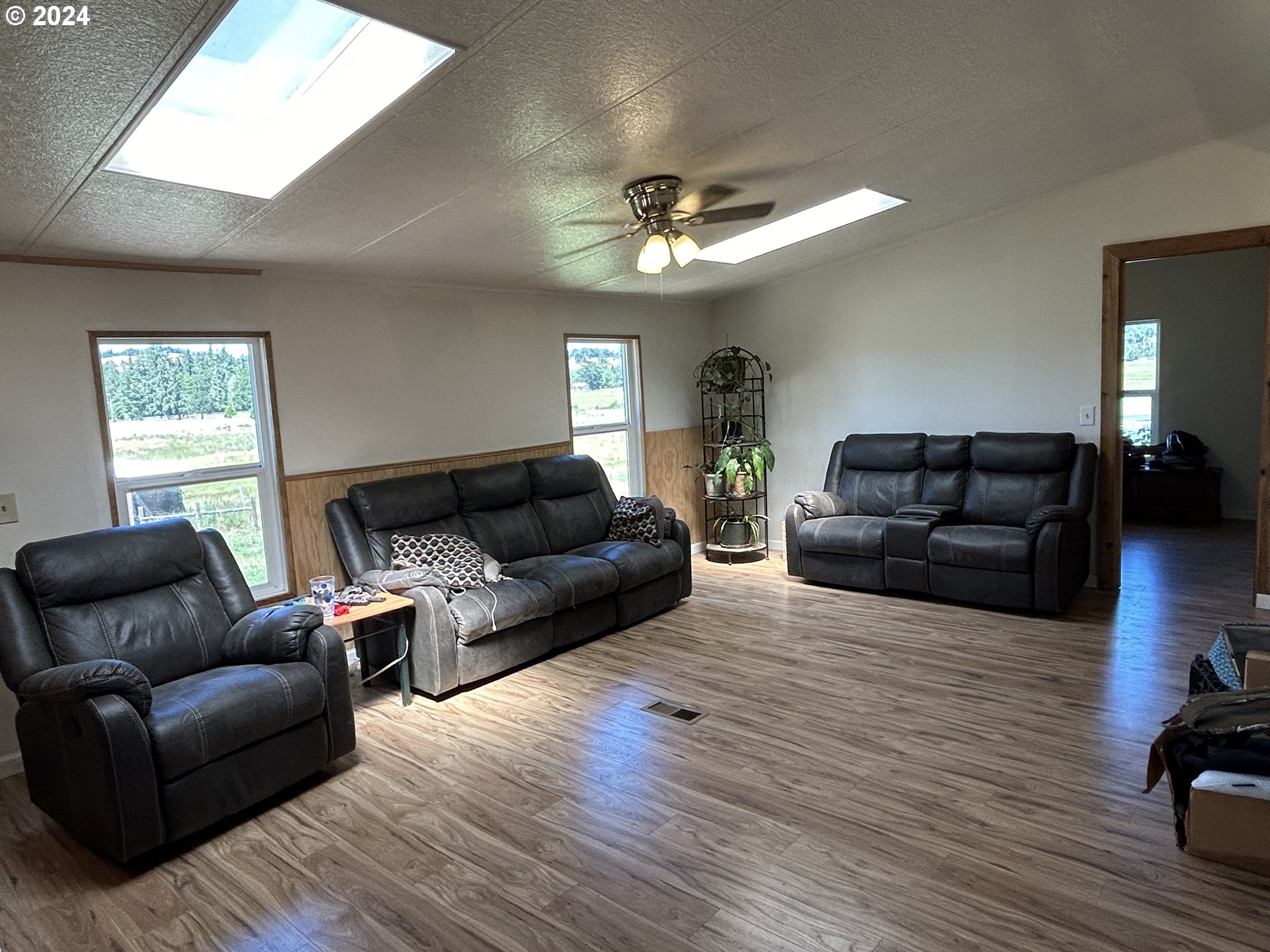 5480 Nonpareil Road Sutherlin, OR 97479 - Photo 10 of 44 a living room with furniture a flat screen tv and wooden floor