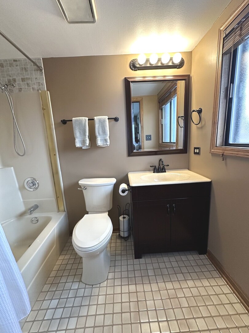 16806 82nd Avenue, Unit 3S Tinley Park, IL 60477 - Photo 8 of 14 a bathroom with a sink vanity mirror and toilet