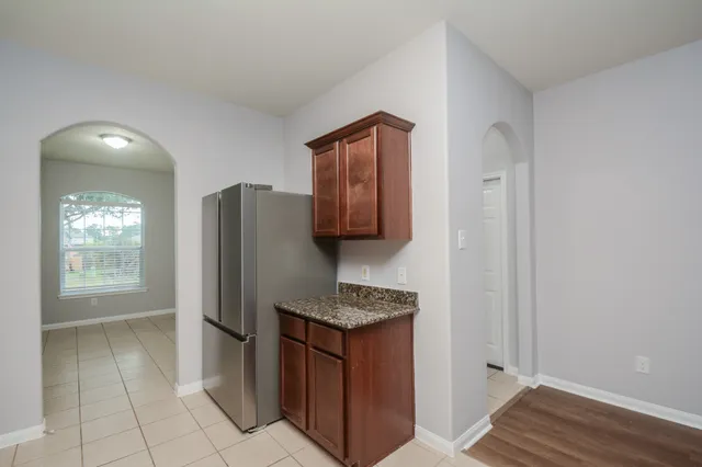 a kitchen with stainless steel appliances granite countertop a refrigerator and a sink