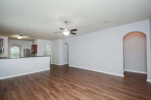 a view of a room with wooden floor and chandelier