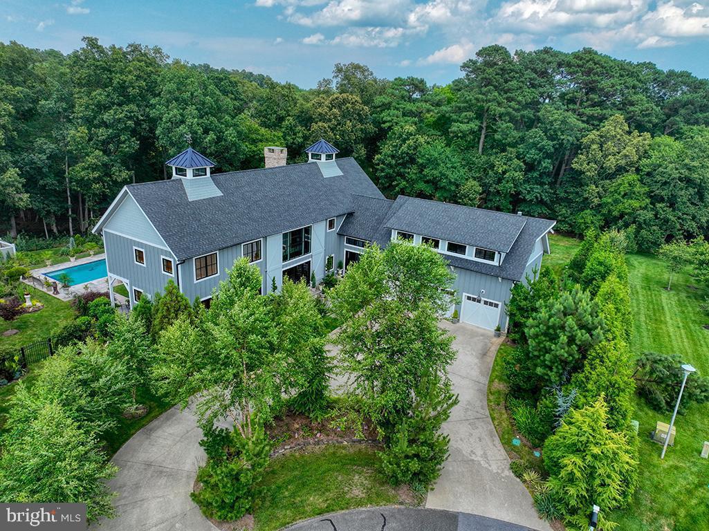 an aerial view of a house with yard and outdoor seating