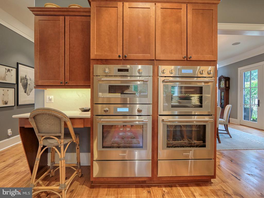 35975 Goshawk Court Lewes, DE 19958 - Photo 21 of 94 a kitchen with stainless steel appliances granite countertop a stove and a microwave