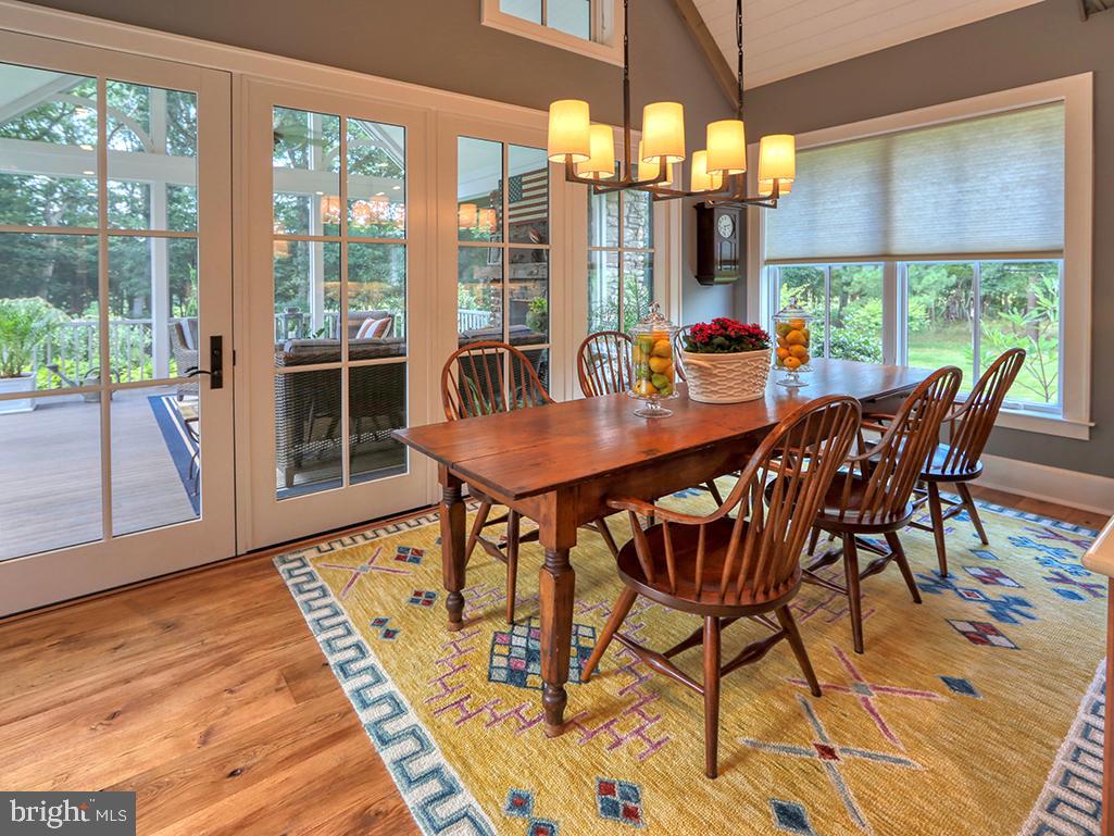 35975 Goshawk Court Lewes, DE 19958 - Photo 27 of 94 a view of a dining room with furniture wooden floor and chandelier