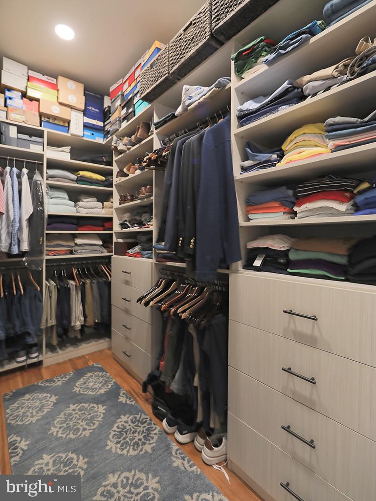 35975 Goshawk Court Lewes, DE 19958 - Photo 34 of 94 a view of walk in closet with clothes and shoes