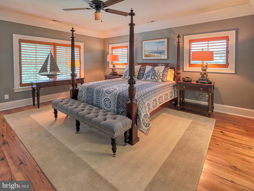 35975 Goshawk Court Lewes, DE 19958 - Photo 55 of 94 a spacious bedroom with a bed and wooden floor