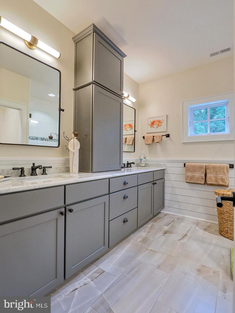 35975 Goshawk Court Lewes, DE 19958 - Photo 56 of 94 a spacious bathroom with a granite countertop sink mirror and a