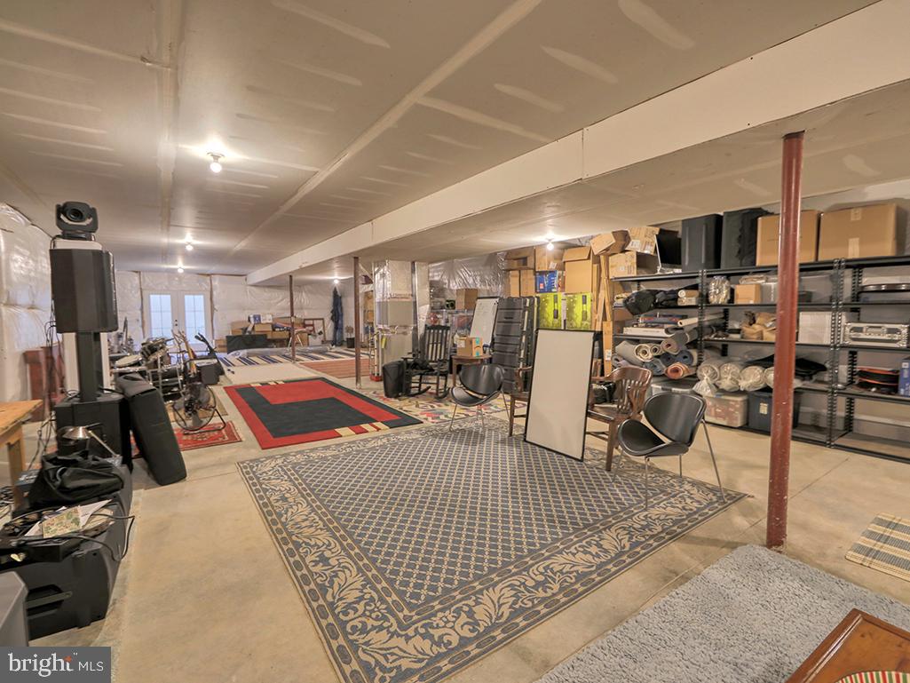 35975 Goshawk Court Lewes, DE 19958 - Photo 67 of 94 a living room with lots of furniture and a rug