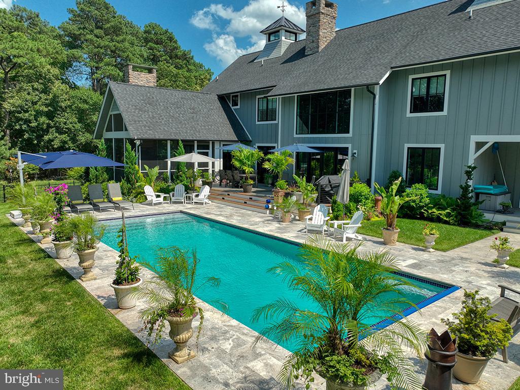 35975 Goshawk Court Lewes, DE 19958 - Photo 69 of 94 a view of a house with pool and chairs