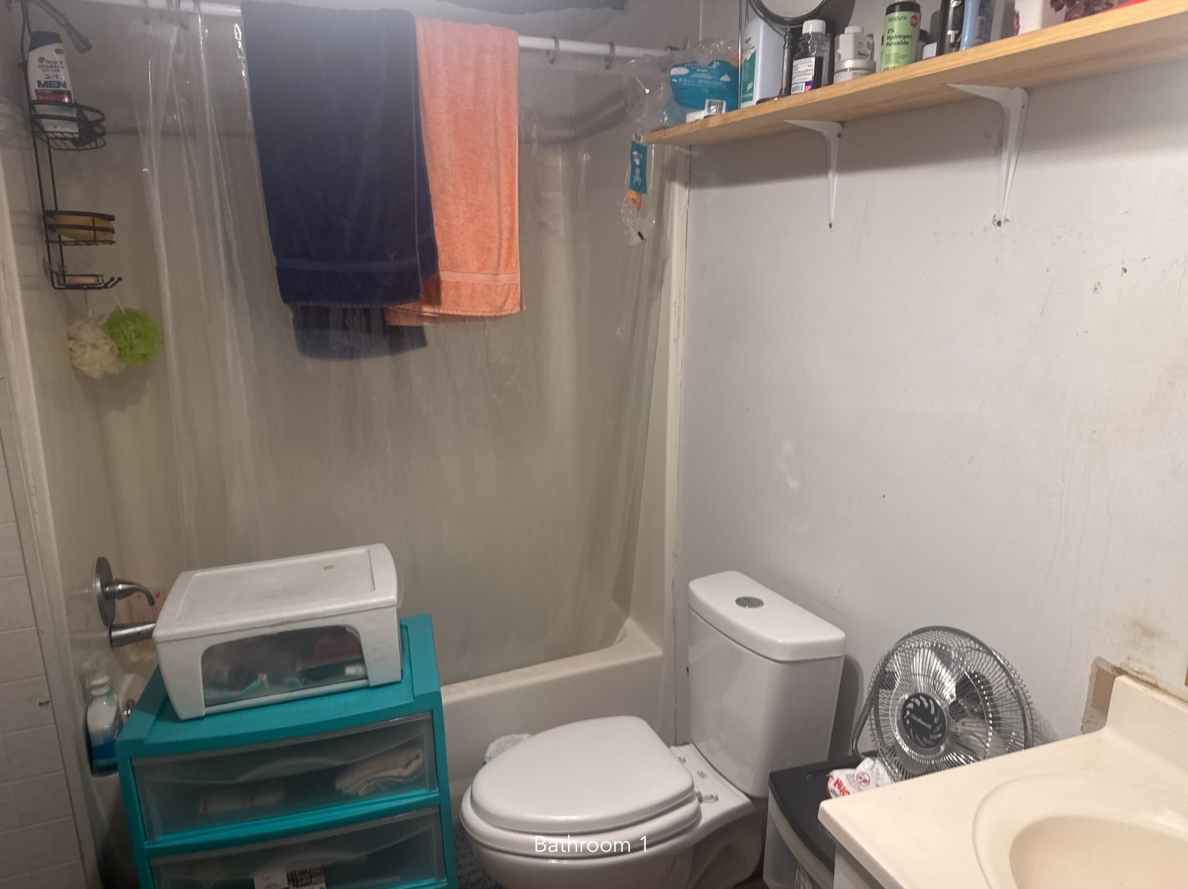 1047 Perry Switch Road Jackson, TN 38301 - Photo 35 of 36 a white toilet sitting next to a bathroom sink and vanity