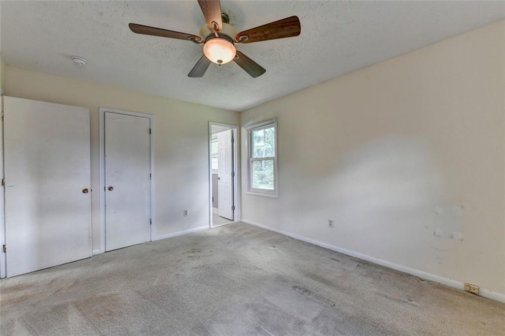 1577 Harbour Oaks Road Tucker, GA 30084 - Photo 30 of 58 an empty room with chandelier fan