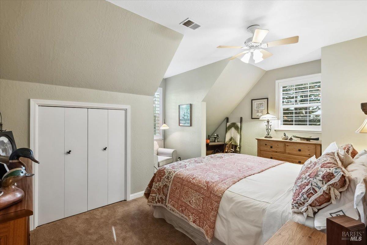 5701 Ridgewood Road Willits, CA 95490 - Photo 42 of 84 a bedroom with a large bed and a chandelier