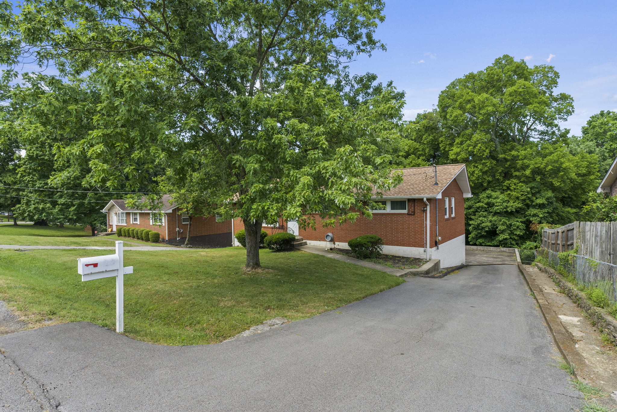 311 Bonnahurst Drive Hermitage, TN 37076 - Photo 4 of 47 a front view of a house with a yard and trees