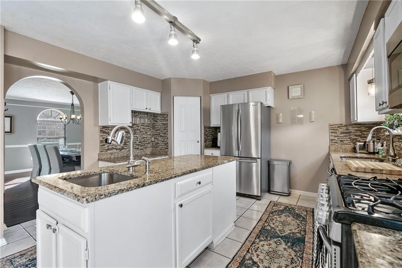 3013 Meyeridge Road Pittsburgh, PA 15209 - Photo 14 of 27 a kitchen with stainless steel appliances granite countertop a sink stove and refrigerator