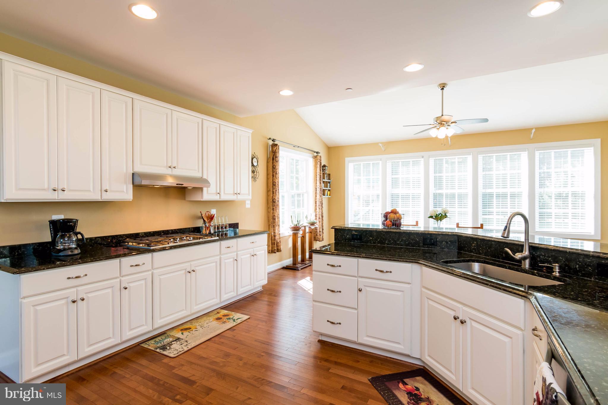 3333 Whispering Highland Road Finksburg, MD 21048 - Photo 11 of 30 a kitchen with granite countertop white cabinets and white appliances